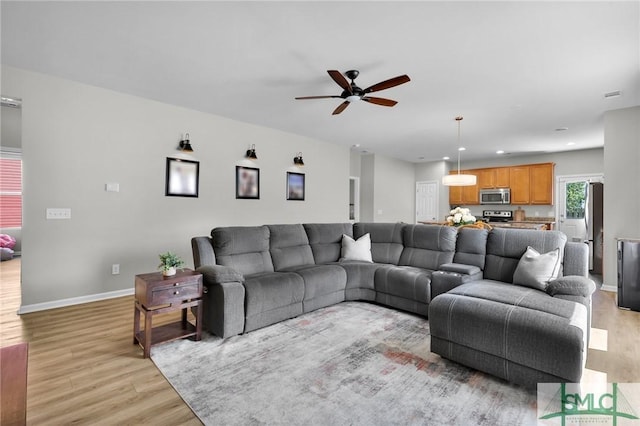 living area with recessed lighting, light wood-style flooring, baseboards, and ceiling fan