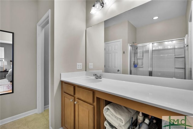 bathroom featuring connected bathroom, baseboards, recessed lighting, a stall shower, and vanity