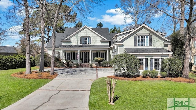 view of front of property with a front yard and concrete driveway