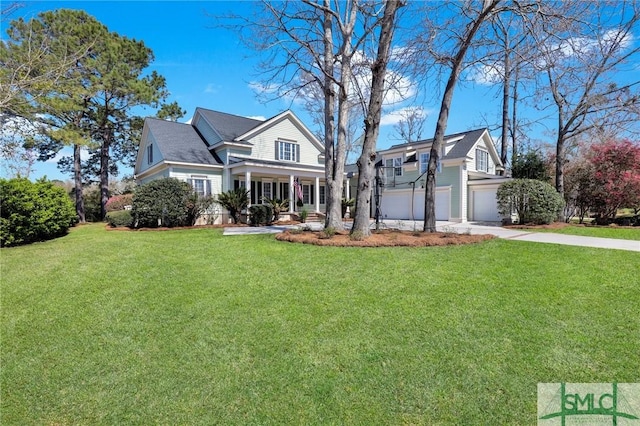 view of front of home featuring a front lawn, an attached garage, a porch, and driveway