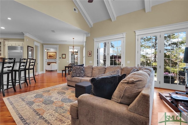 living room with crown molding, a chandelier, beamed ceiling, recessed lighting, and wood finished floors