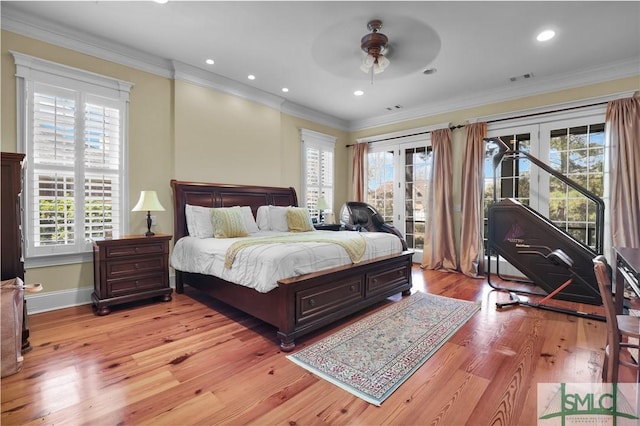 bedroom featuring multiple windows, crown molding, and access to outside