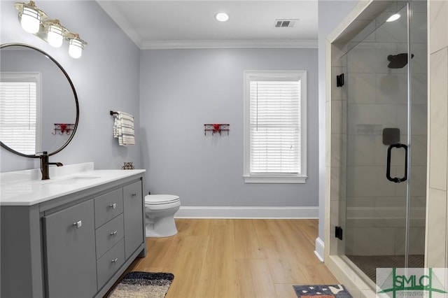 bathroom featuring a shower stall, crown molding, baseboards, and wood finished floors