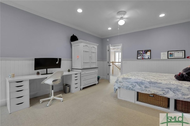 bedroom featuring recessed lighting, a wainscoted wall, light colored carpet, and crown molding