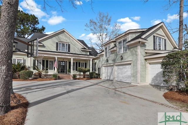 view of front of house featuring an attached garage, covered porch, and driveway