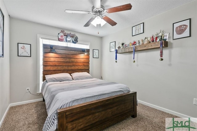 bedroom with carpet flooring, a textured ceiling, a ceiling fan, and baseboards