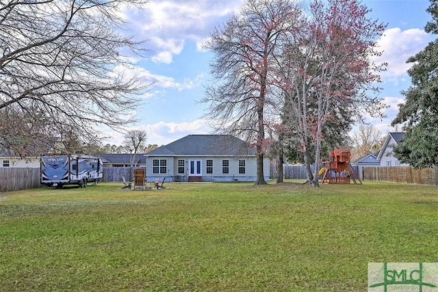 view of yard featuring a playground and a fenced backyard