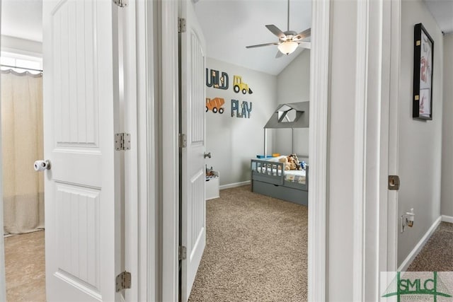 bedroom with lofted ceiling, carpet flooring, and baseboards