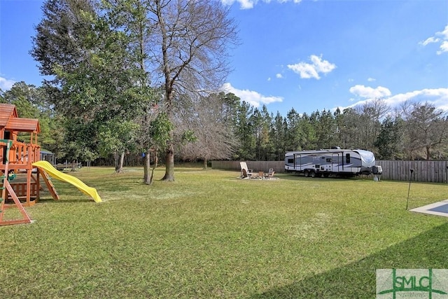 view of yard featuring a playground and fence