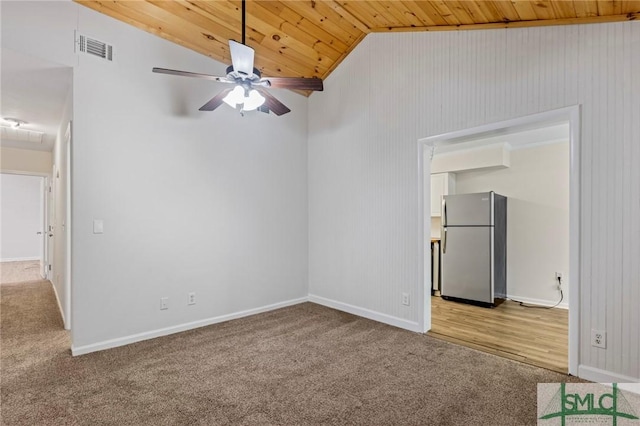 unfurnished bedroom featuring visible vents, light carpet, freestanding refrigerator, wooden ceiling, and lofted ceiling