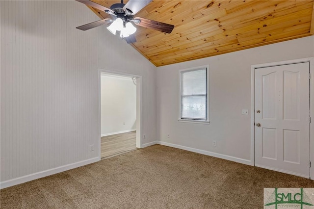 unfurnished room featuring lofted ceiling, a ceiling fan, baseboards, and carpet floors