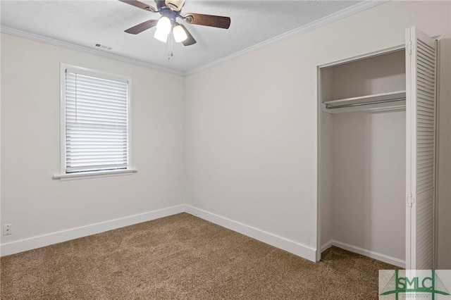 unfurnished bedroom with visible vents, carpet, and crown molding