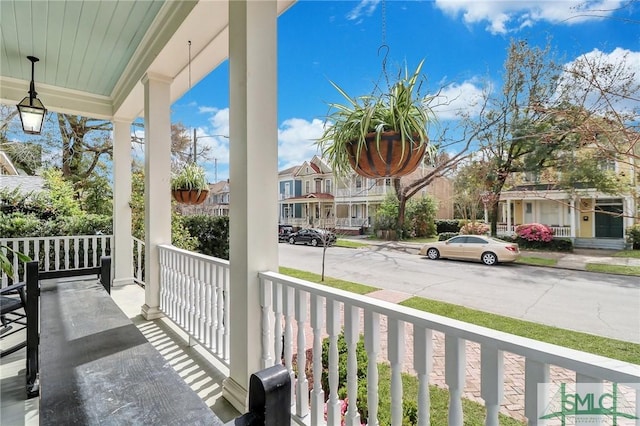 balcony featuring a residential view and covered porch