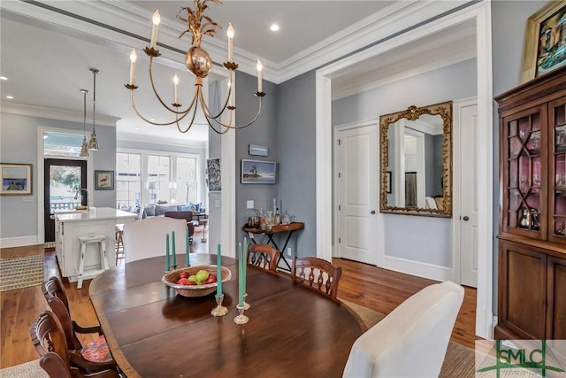 dining area featuring recessed lighting, wood finished floors, baseboards, and ornamental molding