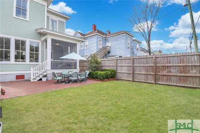 view of yard with a sunroom, a patio, and fence