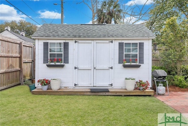 view of shed with a fenced backyard