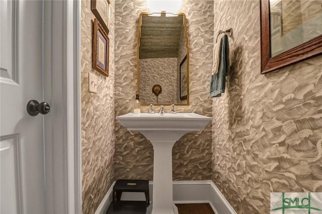 bathroom featuring wallpapered walls