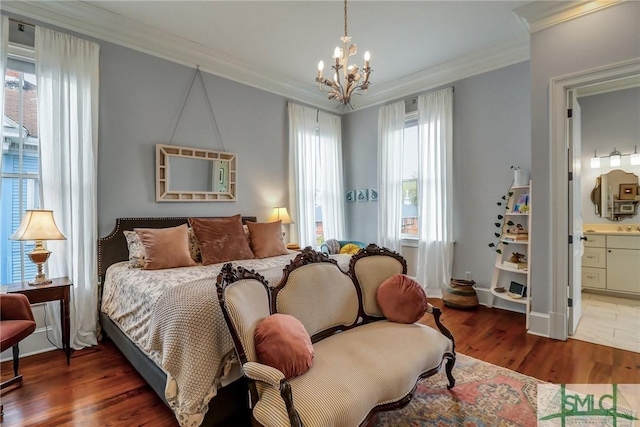 bedroom featuring a notable chandelier, ensuite bathroom, crown molding, and wood finished floors