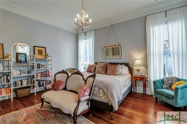 bedroom with crown molding, an inviting chandelier, and wood finished floors