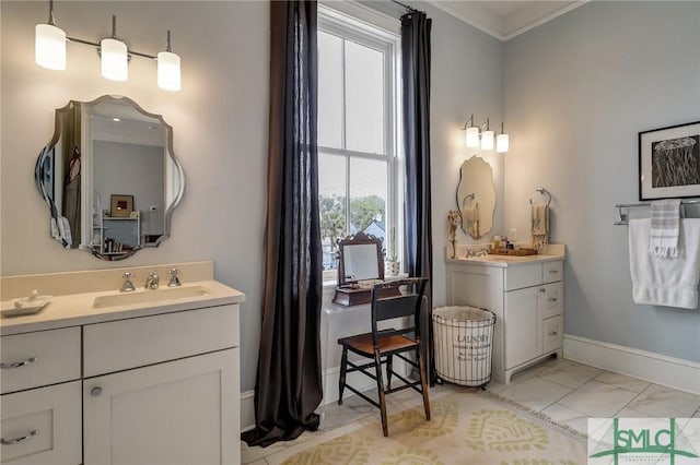 full bathroom featuring marble finish floor, two vanities, a sink, crown molding, and baseboards