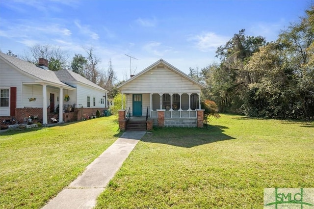 bungalow-style home with a porch and a front lawn