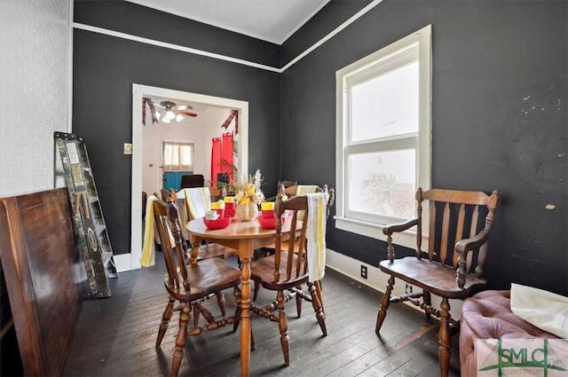 dining space with hardwood / wood-style floors, baseboards, and a wealth of natural light