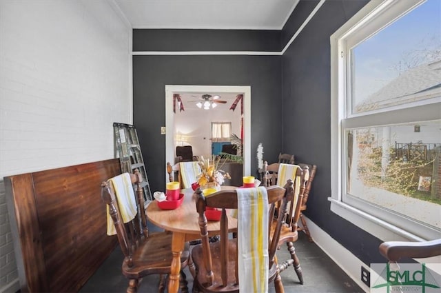 dining area with baseboards and ceiling fan