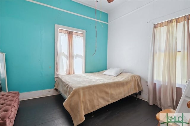 bedroom featuring dark wood-style floors, ceiling fan, and baseboards