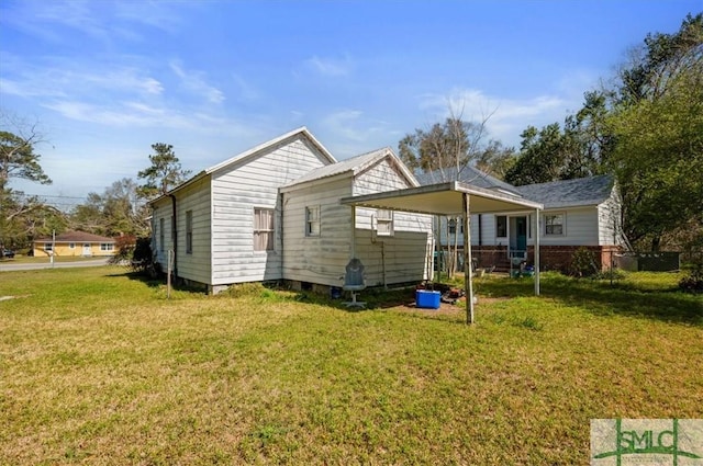 back of house with a lawn