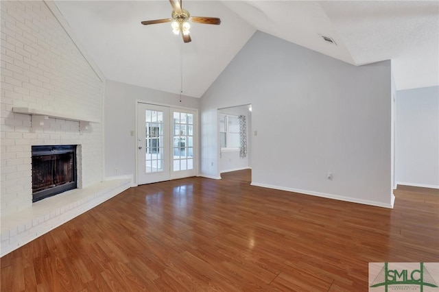 unfurnished living room with visible vents, wood finished floors, and a ceiling fan