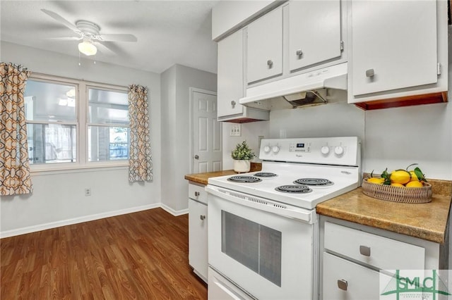 kitchen featuring dark wood-type flooring, ceiling fan, under cabinet range hood, electric range, and white cabinetry