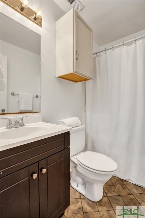 bathroom with visible vents, toilet, a shower with shower curtain, tile patterned flooring, and vanity