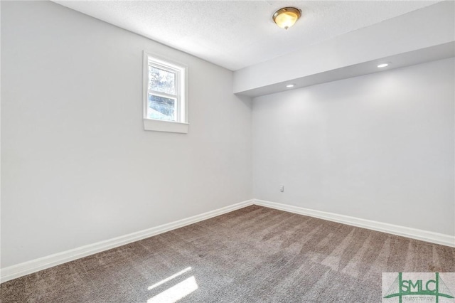 below grade area with recessed lighting, a textured ceiling, baseboards, and carpet floors