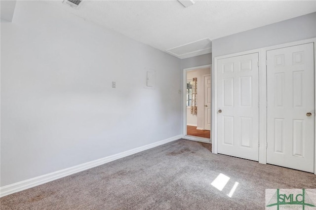 unfurnished bedroom featuring visible vents, carpet, and baseboards