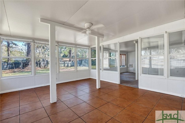 unfurnished sunroom with a ceiling fan