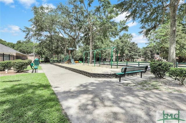 view of community with playground community, a yard, and fence