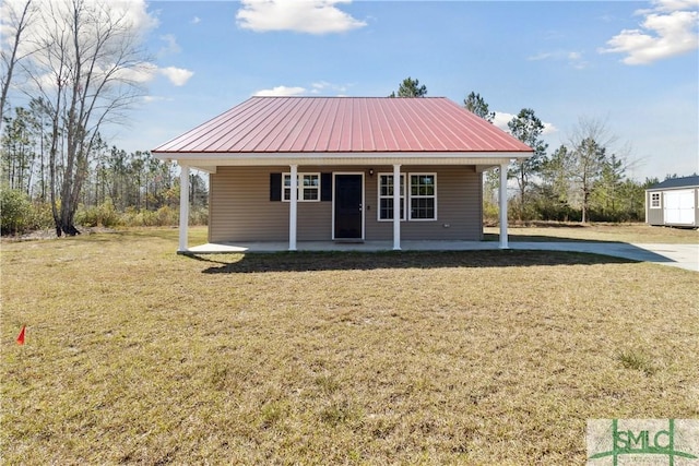 view of front facade with a front lawn, a porch, and metal roof