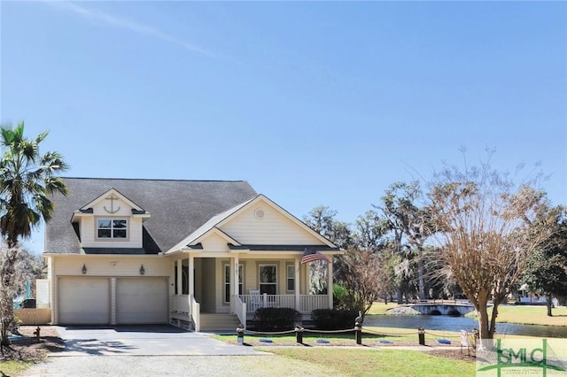 view of front of property with driveway, roof with shingles, a porch, a water view, and a garage