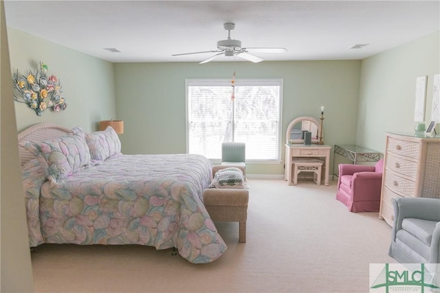 carpeted bedroom featuring a ceiling fan and visible vents