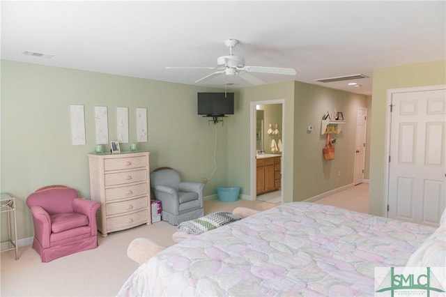 bedroom with visible vents, light colored carpet, baseboards, and ceiling fan