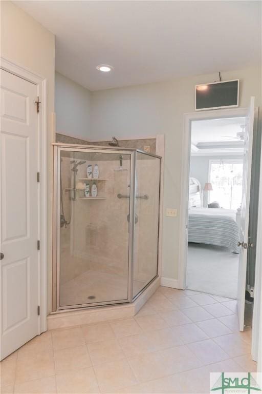 ensuite bathroom featuring tile patterned floors, a shower stall, and ensuite bathroom