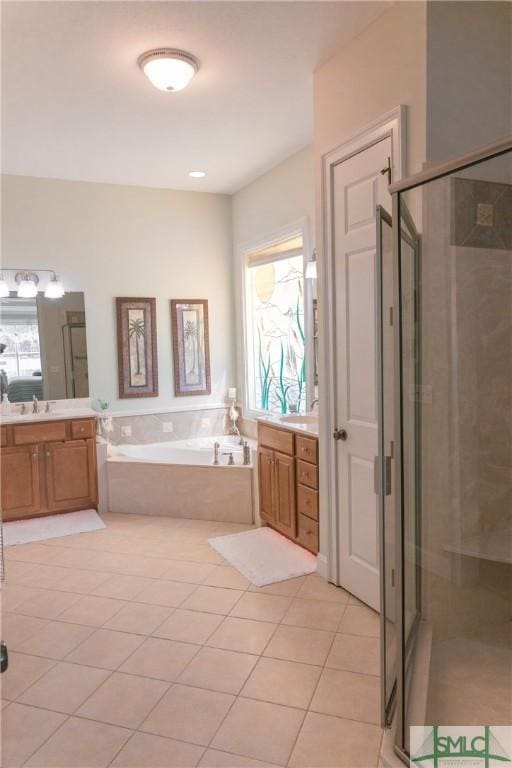 bathroom with vanity, a garden tub, and a shower stall