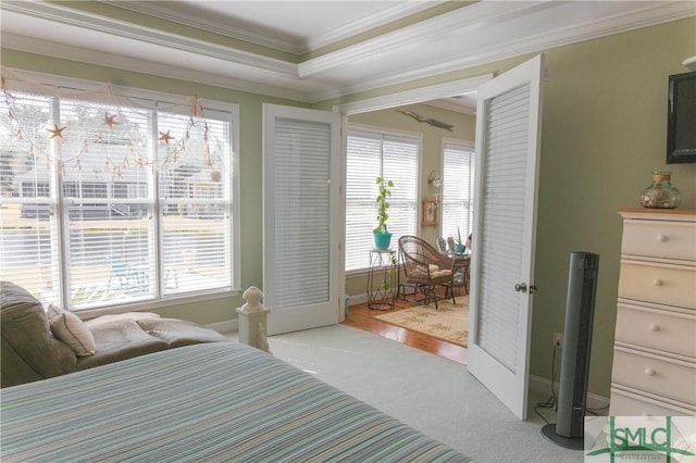 carpeted bedroom with baseboards and ornamental molding