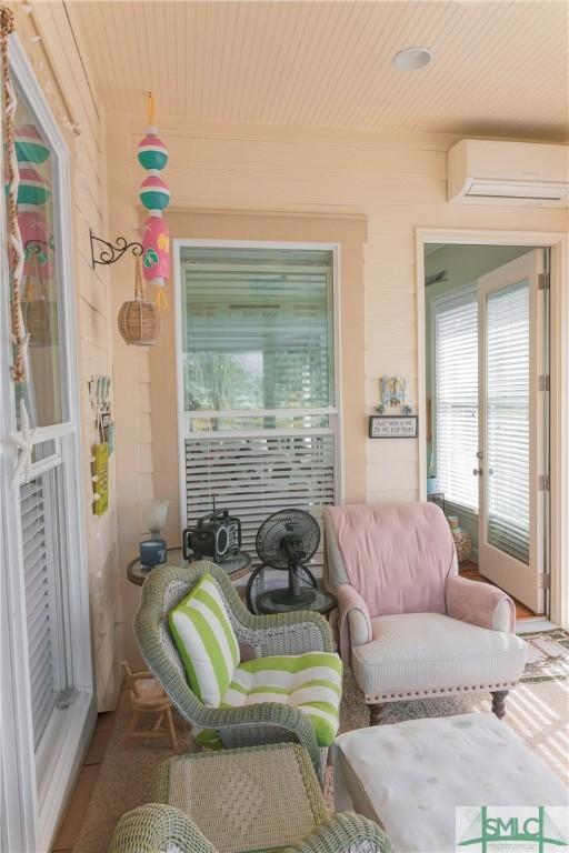 view of patio with a wall unit AC