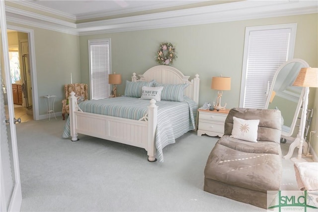 carpeted bedroom with crown molding and baseboards