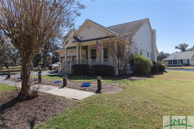 view of front facade featuring covered porch and a front yard