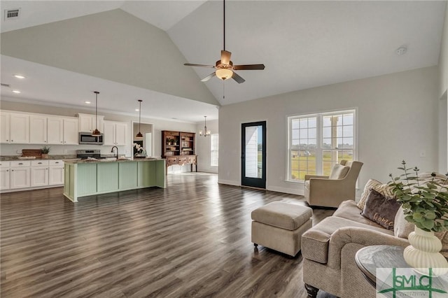 living room featuring visible vents, high vaulted ceiling, ceiling fan with notable chandelier, dark wood finished floors, and baseboards