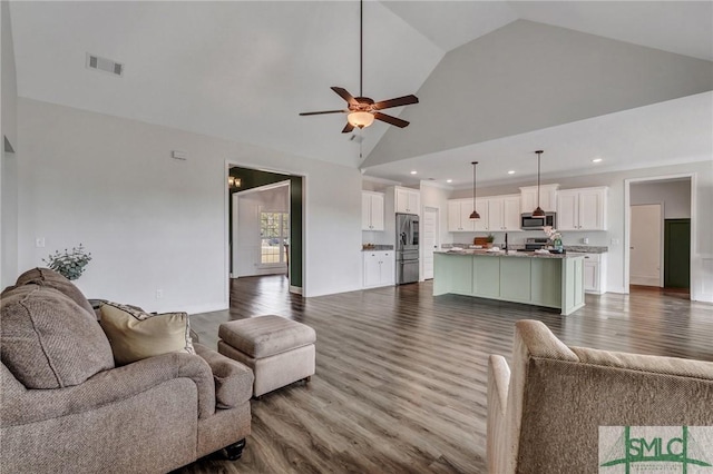 living area with visible vents, dark wood-type flooring, ceiling fan, recessed lighting, and high vaulted ceiling