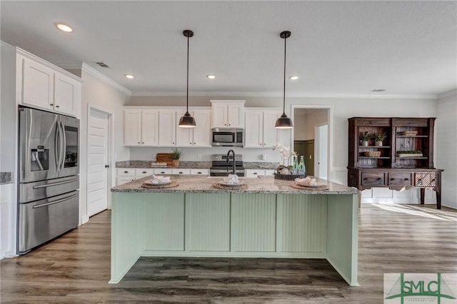 kitchen featuring light stone countertops, dark wood finished floors, a large island, white cabinets, and appliances with stainless steel finishes