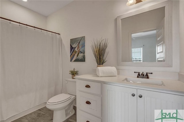 bathroom featuring vanity, a shower with shower curtain, toilet, and tile patterned floors